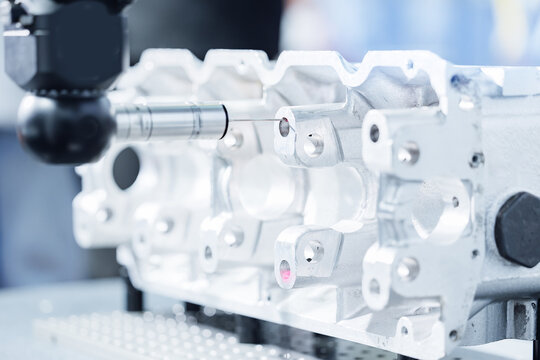 Cnc coordinate measuring machine inspecting metal engine block