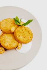 Cottage cheese pancakes with sour cream and kumquats