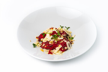 Beetroot carpaccio serving, plated with almonds and cheese