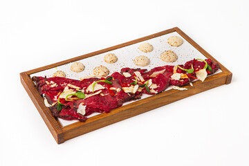 Gourmet beef carpaccio appetizer featuring parmesan and sauce
