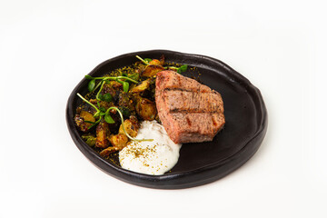 Grilled tuna steak serving with roasted vegetables on plate