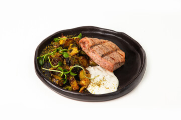 Grilled tuna steak with roasted vegetables and creamy sauce