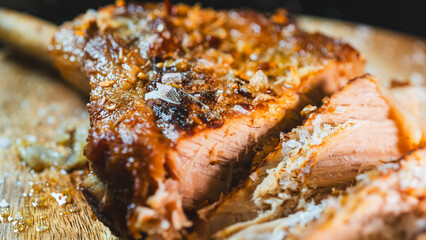 Freshly sliced, juicy grilled pork chop with the bone-in, revealing a perfectly cooked interior....