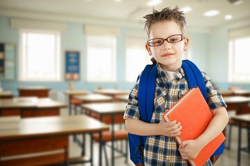 Happy child school student in classroom for learning