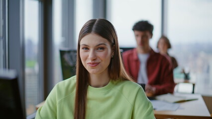 Fototapeta premium Closeup coworking member woman using computer. Happy students sitting in row