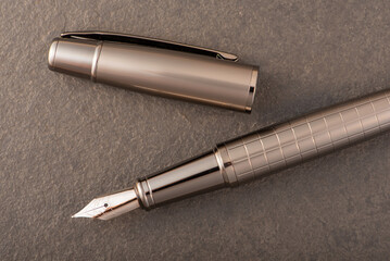 Fountain pen, beautiful fountain pen on rustic stone surface, selective focus.