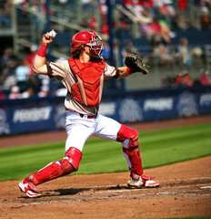 baseball catcher throwing a runner out