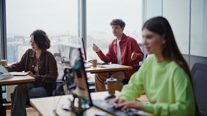 Smiling coworkers laughing together clapping hands panoramic workplace closeup