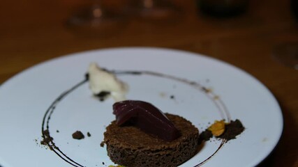 delicious freshly made chocolate sacher cake on a plate on white background drizzled with hot chocolate dessert concept. High quality 4k footage