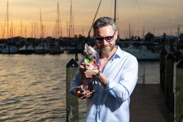 Fashion business man near the yacht. Portrait of fashion model outdoor. Fashion male posing near yachts. Fashion man in urban style. Handsome hispanic man at yacht club. Man in gulf near luxury yacht.