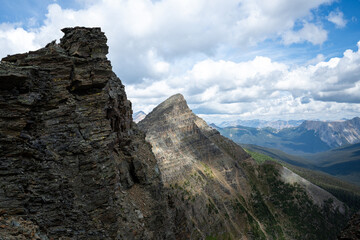 Rocky mountain peak against a blue cloudy sky