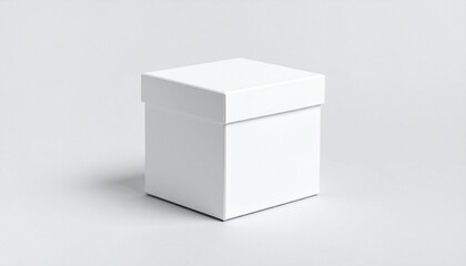 A simple white cube box with a lid sitting on a plain white surface in a studio setting neutral tone