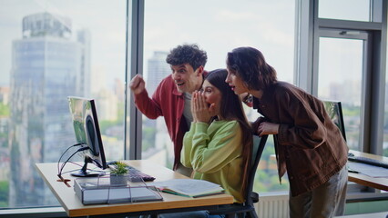 Team members excited achievement in office coworking space. Happy winners rejoicing