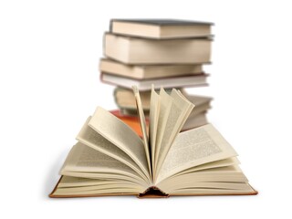 stack of school reading books on wooden desk