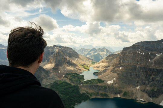 Man overlooking scenic mountain landscape with lake