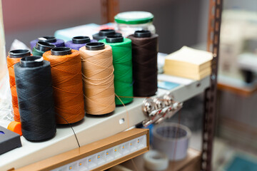 Colorful spools of durable leather thread. Leather Sewing Spools Threads. Multiple spools of strong leather sewing thread in vibrant colors for artisan crafting and handmade accessories.