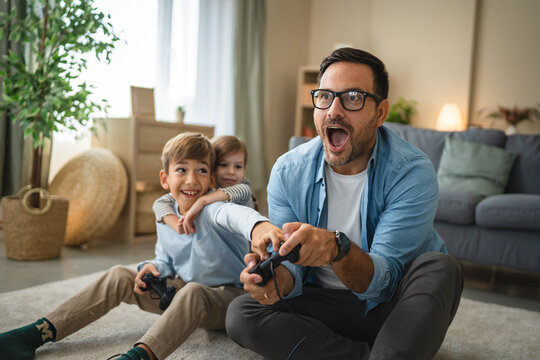 Father and kids spending time playing video games