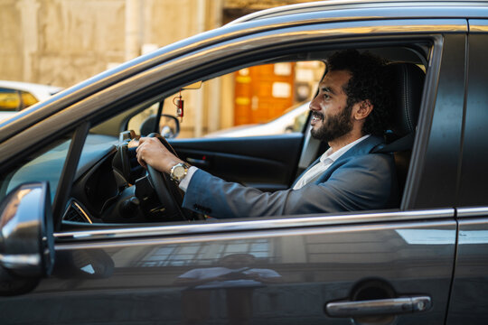 Businessman driving car during daily commute in city