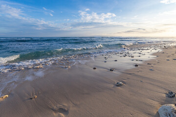 The beach is empty and the water is calm