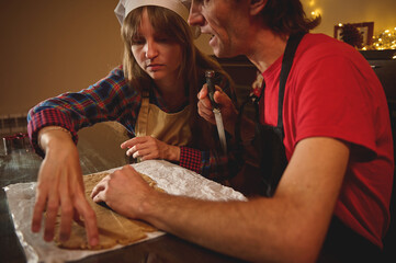 Two People Baking Together At Home: Woman In Apron And Man With Knife Rolling Dough For Pastry