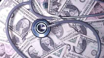 The economics of health. A doctor's stethoscope on a rotating dollar bill - Powered by Adobe