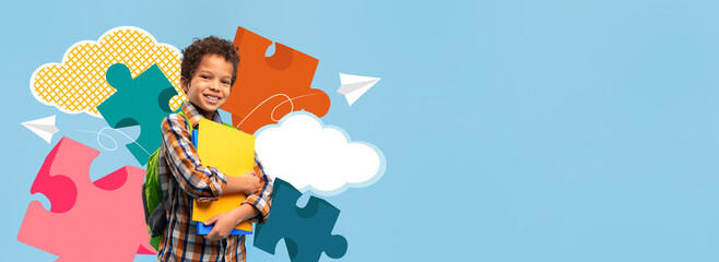 A young boy stands happily holding books and a school folder. He is wearing a backpack and smiling. The background features bright puzzle pieces and clouds, creating a fun atmosphere for school.