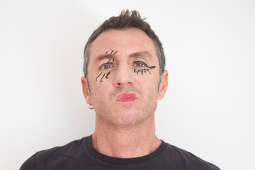 Fototapeta premium Portrait of forty-year-old man with eyes and mouth made up for Halloween. The man is forty years old and of Caucasian origin 
