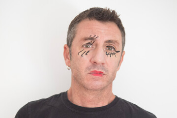 Fototapeta premium Portrait of forty-year-old man with eyes and mouth made up for Halloween. The man is forty years old and of Caucasian origin 