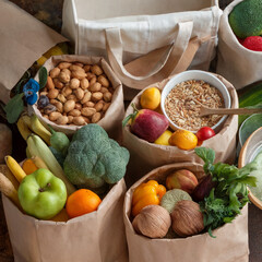 Zero waste delivery concept. Eco-friendly packing. Paper bags with organic food, zero waste shopping, sustainable living, plasticfree. Top view.