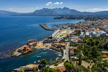 Obraz premium Sant Elia bay beach in Porticello town, Santa Flavia, Sicily, Italy, aerial drone view of Sicilian turquoise waters, rocky cliffs, colorful houses, and Mediterranean coastline panorama in Bagheria