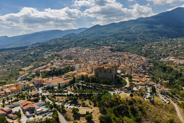 Obraz premium Aerial drone view of Castelbuono medieval town in the Madonie Mountains, Sicily, Italy, basking under the summer sun with historic streets, Ventimiglia Castle. Old mountain town in Sicily