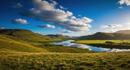 Panoramic view of a tranquil river valley, sunlit hills, and fluffy clouds