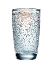 Glass of sparkling water with bubbles on a black background.