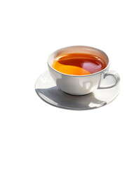 A white teacup filled with tea sits on a saucer, casting a shadow.