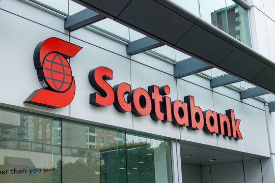 Bold red Scotiabank logo on sleek modern bank facade with glass windows