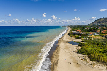 Aerial drone view of Lascari Beach, a scenic coastal area near the Madonie Mountains in northern Sicily, Italy, golden sand, turquoise Tyrrhenian Sea waters, and a peaceful Mediterranean landscape