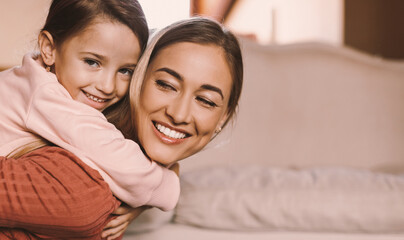 Portrait of Happy Loving Family Of Two Relaxing And Playing At Home, Cute Child Hugging Her Mom From Back Enjoying Spending Time Together, Free Copy Space, Selecive Focus