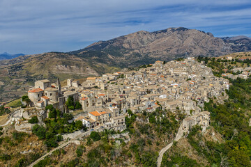 Obraz premium Aerial drone view of Petralia Soprana, a historic Sicilian mountain town with panoramic views of the Madonie Mountains,Petralia Soprana famous Church of Saint Mary of Loreto, Sicily, Italy