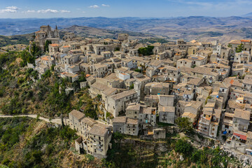 Fototapeta premium Aerial drone view of Petralia Soprana, a historic Sicilian mountain town with panoramic views of the Madonie Mountains,Petralia Soprana famous Church of Saint Mary of Loreto, Sicily, Italy