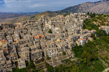 Obraz premium Aerial drone view of Petralia Soprana, a historic Sicilian mountain town with panoramic views of the Madonie Mountains,Petralia Soprana famous Church of Saint Mary of Loreto, Sicily, Italy