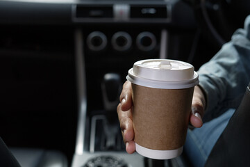 Cup of fresh coffee in the car with the journey
