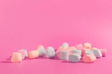 colorful marshmallows on pink background