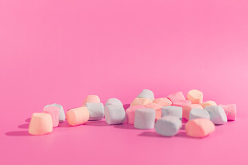 colorful marshmallows on pink background