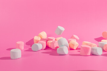 colorful marshmallows on pink background © Maynor