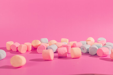 colorful marshmallows on pink background © Maynor