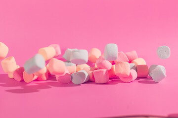 colorful marshmallows on pink background © Maynor