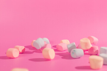 colorful marshmallows on pink background © Maynor