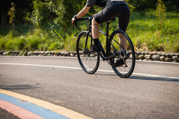Cyclist riding bike at summer park