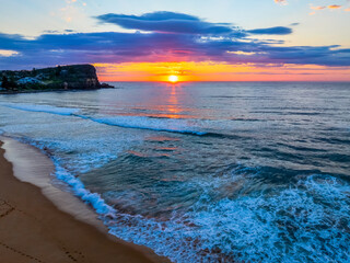 Seaside Sunrise Under a Cloud-Filled Sky