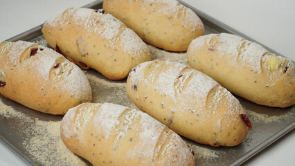 Freshly baked cranberry cream cheese sourdough bread in the oven and placed in an aluminum pan.